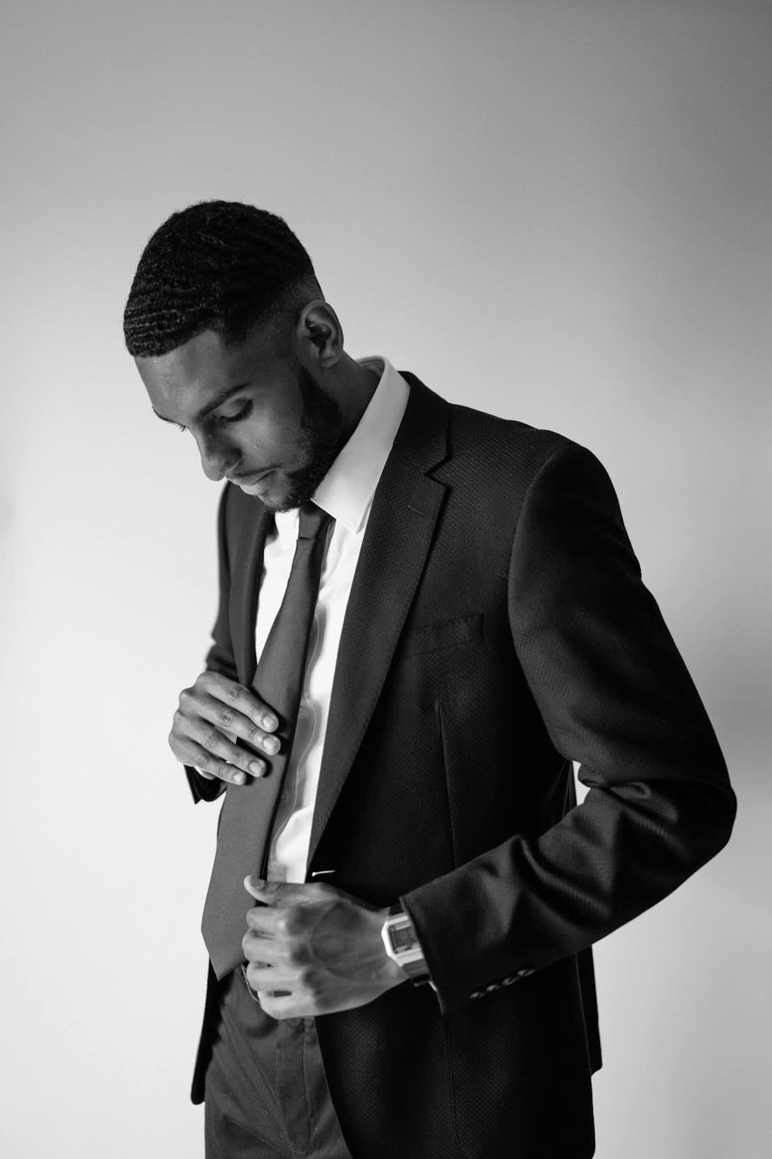 Tailoring — a black suit, studio light