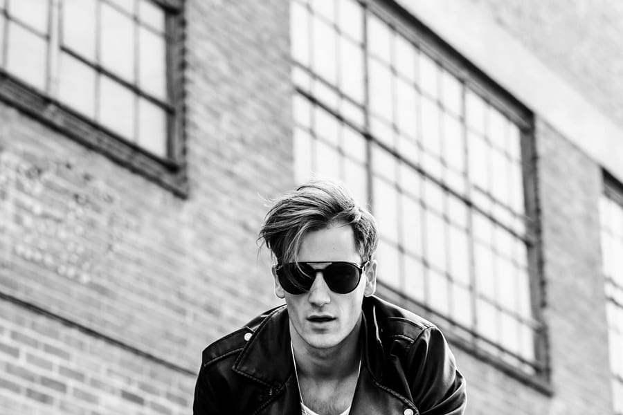Look 05 — a leather jacket, sunglasses, turned collar