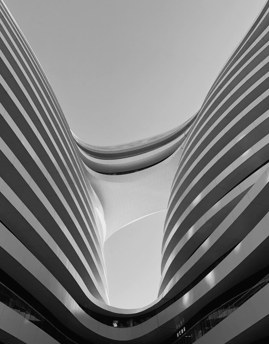 Curved white architecture against the sky