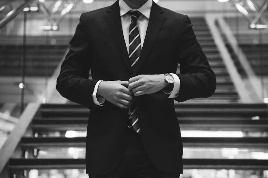 A tailored two-piece, worn, mid-gesture